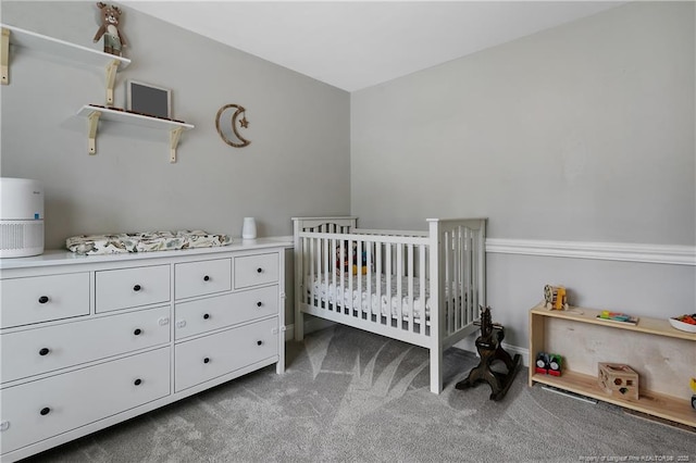 bedroom featuring carpet flooring and a crib