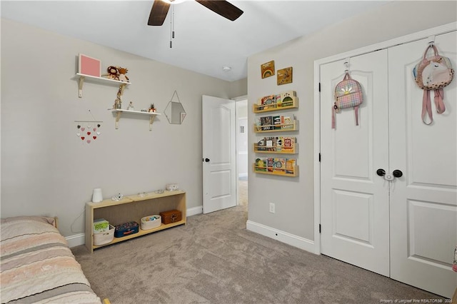 bedroom featuring carpet floors, a closet, baseboards, and a ceiling fan
