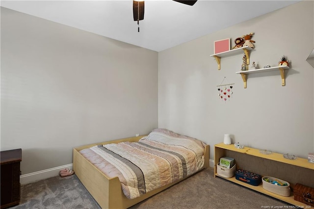 carpeted bedroom featuring baseboards and a ceiling fan