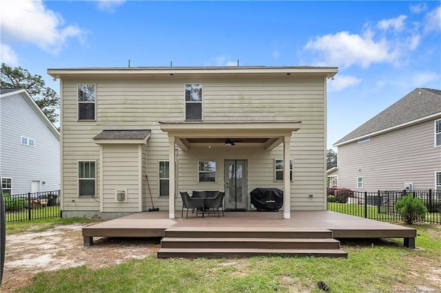 back of house featuring a deck and ceiling fan