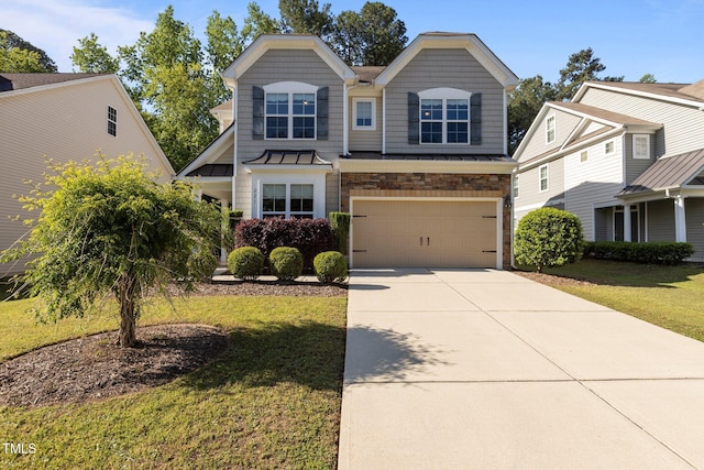 craftsman-style home with a standing seam roof, driveway, a front yard, an attached garage, and stone siding