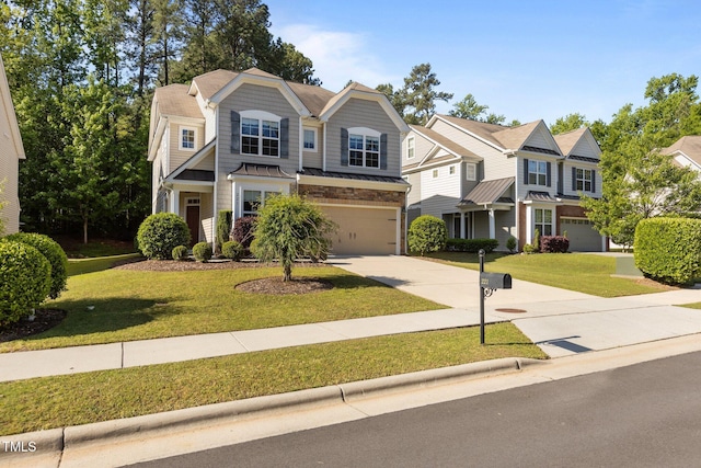 view of front facade with a standing seam roof, concrete driveway, a front lawn, and a garage