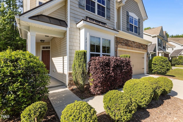 exterior space featuring a garage and stone siding