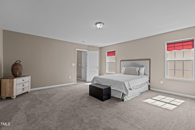 carpeted bedroom featuring baseboards