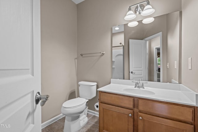 bathroom featuring toilet, baseboards, tile patterned flooring, and vanity