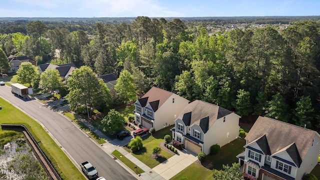 birds eye view of property with a residential view and a view of trees