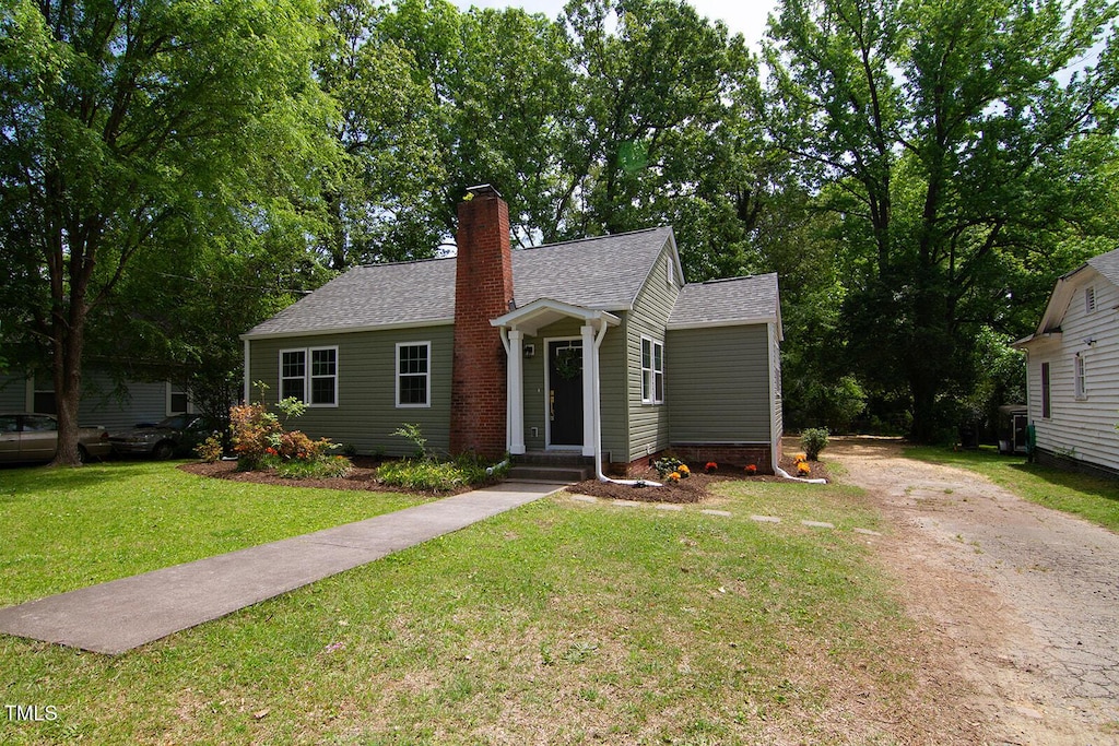 408 E Maynard Ave, Durham, NC 27704 - bungalow featuring driveway, a front lawn, roof with shingles, and a chimney