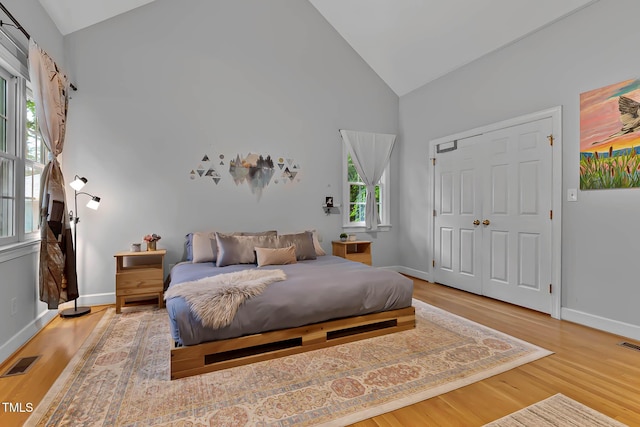 6 Chelan Ct, Durham, NC 27713 - bedroom with high vaulted ceiling, wood finished floors, baseboards, and a closet