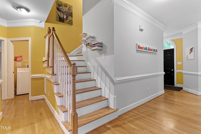6 Chelan Ct, Durham, NC 27713 - staircase with washer / clothes dryer, ornamental molding, hardwood / wood-style flooring, and baseboards