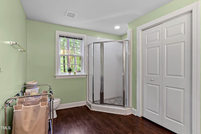 6 Chelan Ct, Durham, NC 27713 - bathroom featuring a shower stall, toilet, baseboards, and wood finished floors