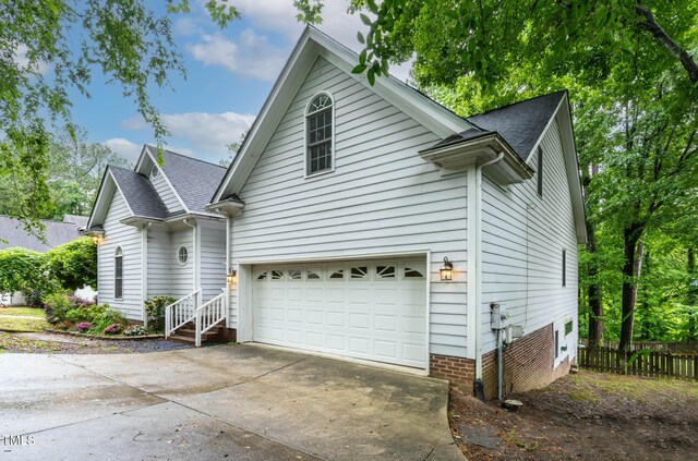 6 Chelan Ct, Durham, NC 27713 - view of home's exterior featuring concrete driveway, a shingled roof, and an attached garage