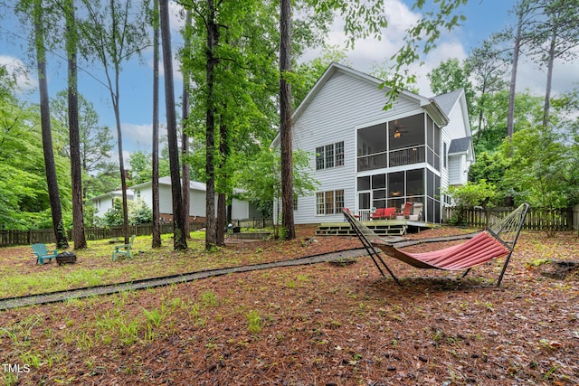6 Chelan Ct, Durham, NC 27713 - back of property with a sunroom, a fire pit, and a fenced backyard