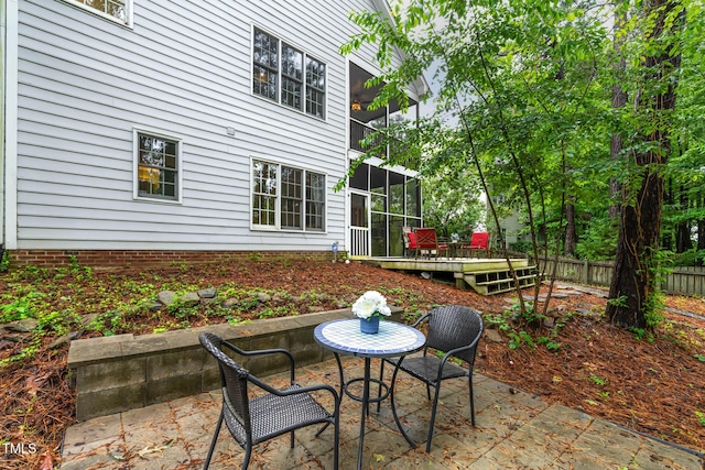 6 Chelan Ct, Durham, NC 27713 - fenced backyard featuring a wooden deck, a patio, and a sunroom