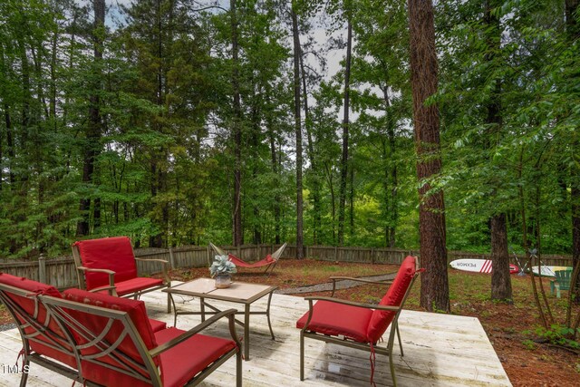 6 Chelan Ct, Durham, NC 27713 - fenced backyard featuring a wooden deck and an outdoor hangout area