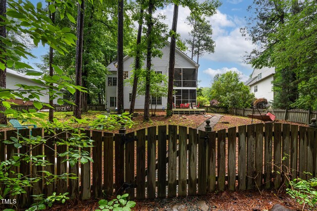 6 Chelan Ct, Durham, NC 27713 - rear view of property featuring a fenced backyard and a sunroom