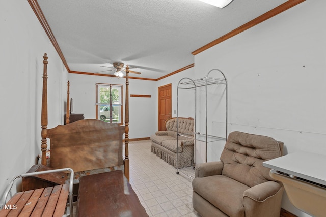 interior space featuring baseboards, ornamental molding, a ceiling fan, and a textured ceiling