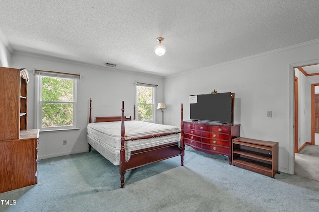 carpeted bedroom with crown molding, a textured ceiling, visible vents, and baseboards