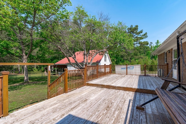 deck with a lawn and fence