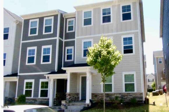 321 Devon Cliffs Dr, Wake Forest, NC 27587 - townhome / multi-family property featuring board and batten siding and stone siding