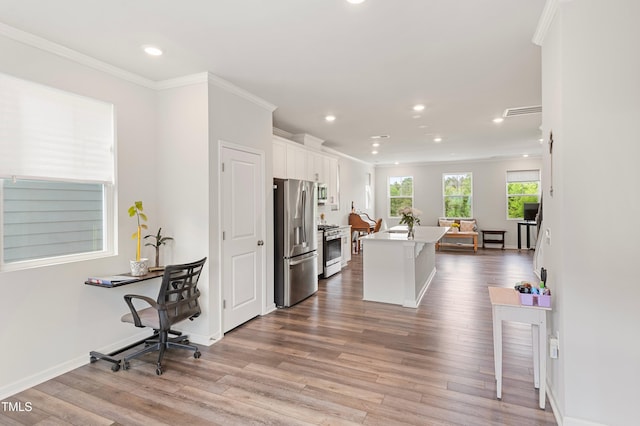 321 Devon Cliffs Dr, Wake Forest, NC 27587 - kitchen featuring appliances with stainless steel finishes, recessed lighting, crown molding, wood finished floors, and white cabinets