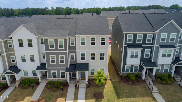 321 Devon Cliffs Dr, Wake Forest, NC 27587 - view of front facade featuring stone siding, a shingled roof, and a residential view