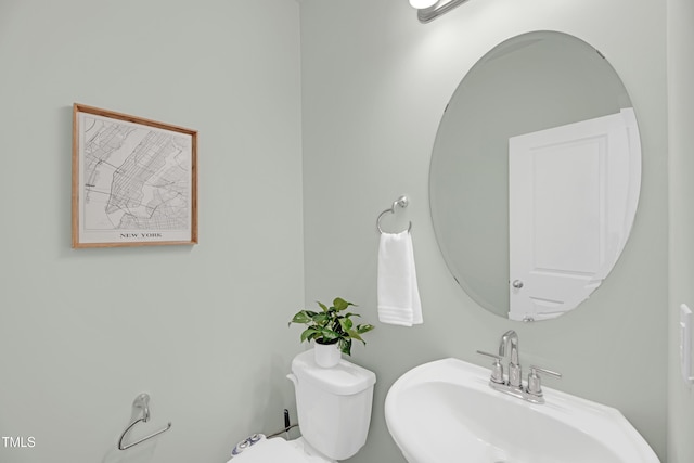 bathroom with toilet and a sink