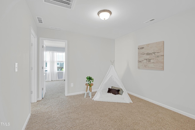 recreation room featuring baseboards, carpet, and visible vents