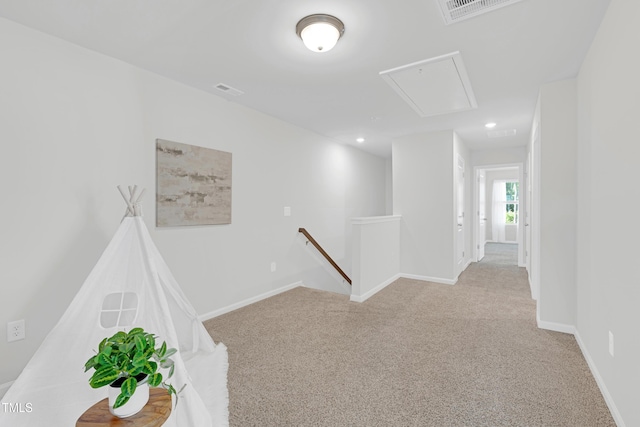rec room with carpet floors, baseboards, attic access, and visible vents
