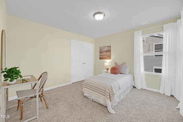 carpeted bedroom featuring visible vents and baseboards