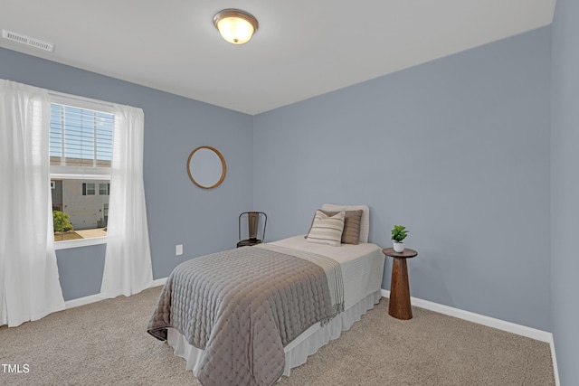 carpeted bedroom featuring baseboards and visible vents