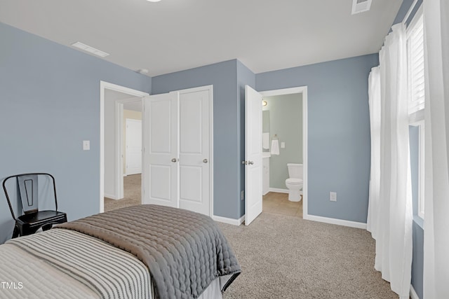 bedroom with carpet floors, baseboards, connected bathroom, and visible vents