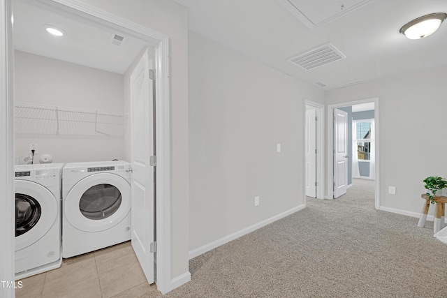 laundry room with laundry area, baseboards, washing machine and dryer, and visible vents
