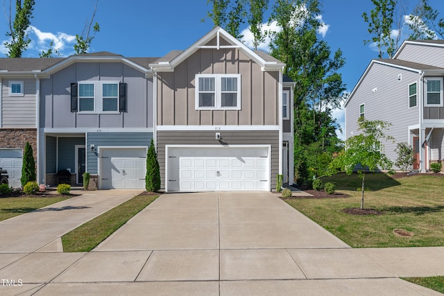view of front of property featuring a garage, board and batten siding, a front yard, and concrete driveway