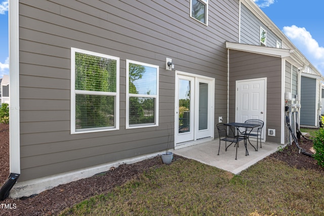 back of house featuring a patio area and a yard