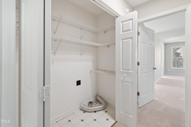 interior space featuring baseboards, laundry area, and hookup for an electric dryer