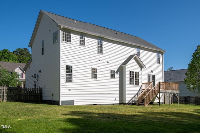 rear view of property featuring crawl space, fence, a wooden deck, and stairway