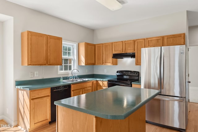 kitchen featuring dark countertops, light wood-type flooring, a sink, black appliances, and under cabinet range hood