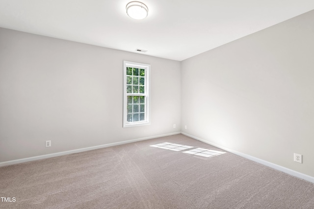 carpeted empty room with baseboards and visible vents