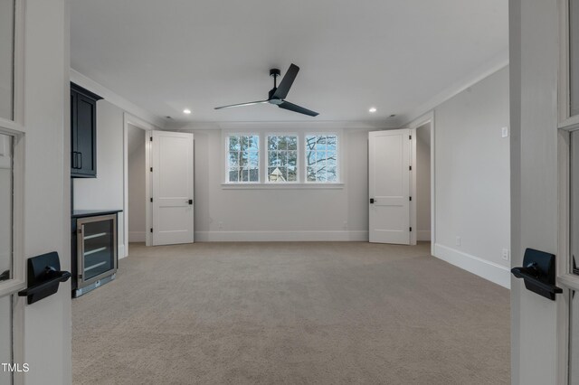 unfurnished bedroom with recessed lighting, baseboards, light carpet, and beverage cooler