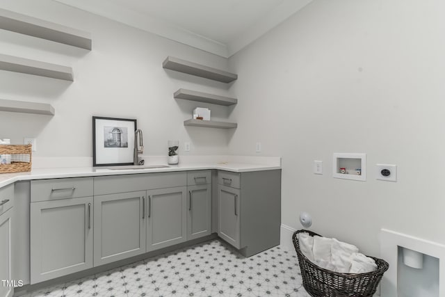 laundry room featuring hookup for an electric dryer, a sink, cabinet space, hookup for a washing machine, and light floors