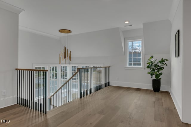 hall with wood finished floors, recessed lighting, visible vents, and baseboards
