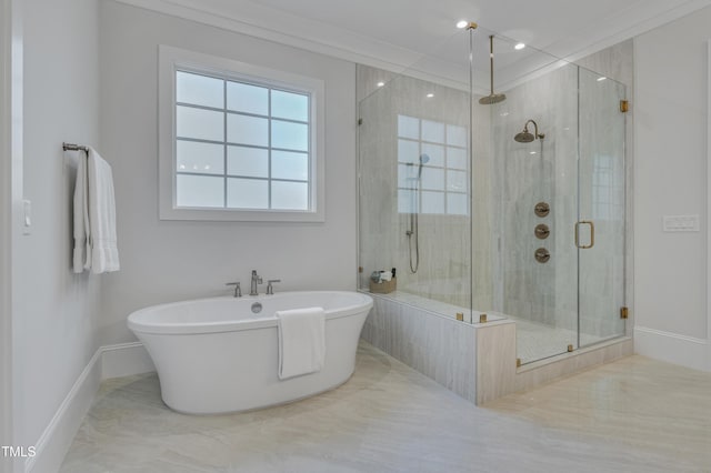 full bathroom featuring a stall shower, a freestanding tub, and baseboards