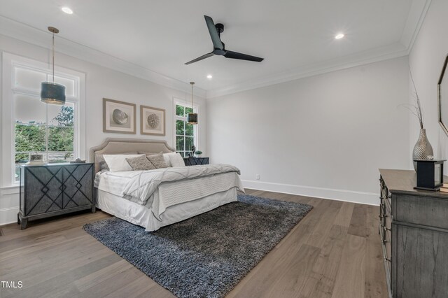 bedroom with recessed lighting, crown molding, dark wood-style floors, and baseboards