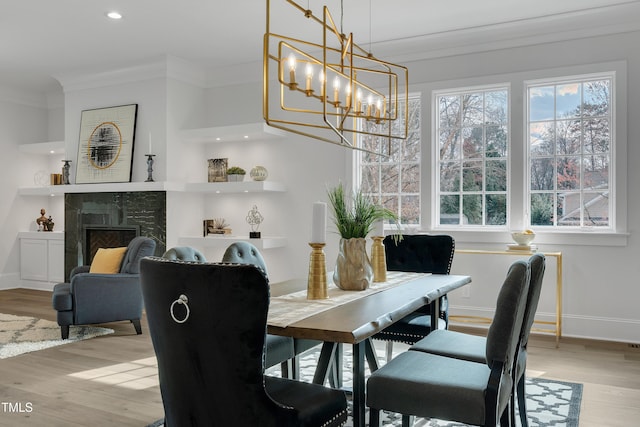 dining area with baseboards, recessed lighting, ornamental molding, wood finished floors, and a notable chandelier