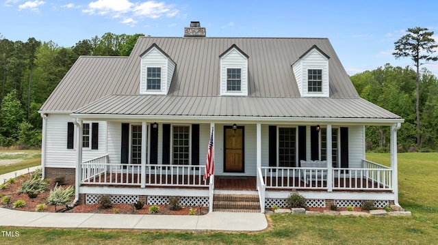 675 Anderson Creek Rd, Henderson, NC 27537 - view of front facade with a porch, a front lawn, a chimney, and metal roof