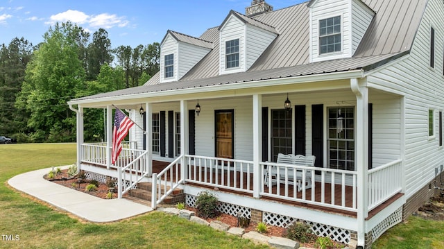 675 Anderson Creek Rd, Henderson, NC 27537 - view of front of property featuring a chimney, covered porch, a front yard, and metal roof