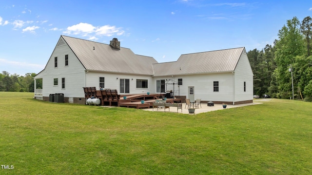 675 Anderson Creek Rd, Henderson, NC 27537 - back of house with a lawn, metal roof, a patio area, and a chimney