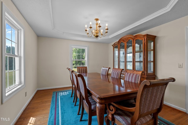 675 Anderson Creek Rd, Henderson, NC 27537 - dining space with an inviting chandelier, baseboards, a raised ceiling, and wood finished floors