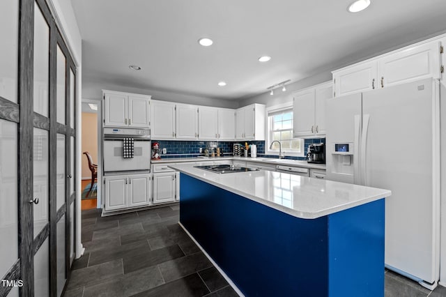 675 Anderson Creek Rd, Henderson, NC 27537 - kitchen with white cabinets, a sink, white appliances, recessed lighting, and decorative backsplash