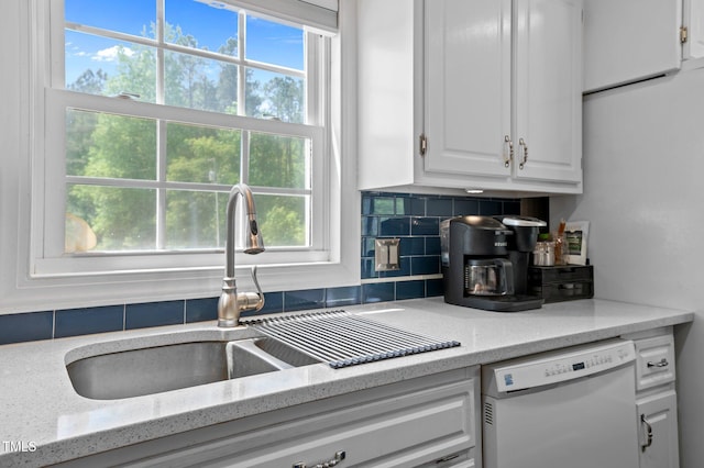 675 Anderson Creek Rd, Henderson, NC 27537 - kitchen featuring a healthy amount of sunlight, backsplash, dishwasher, a sink, and white cabinetry